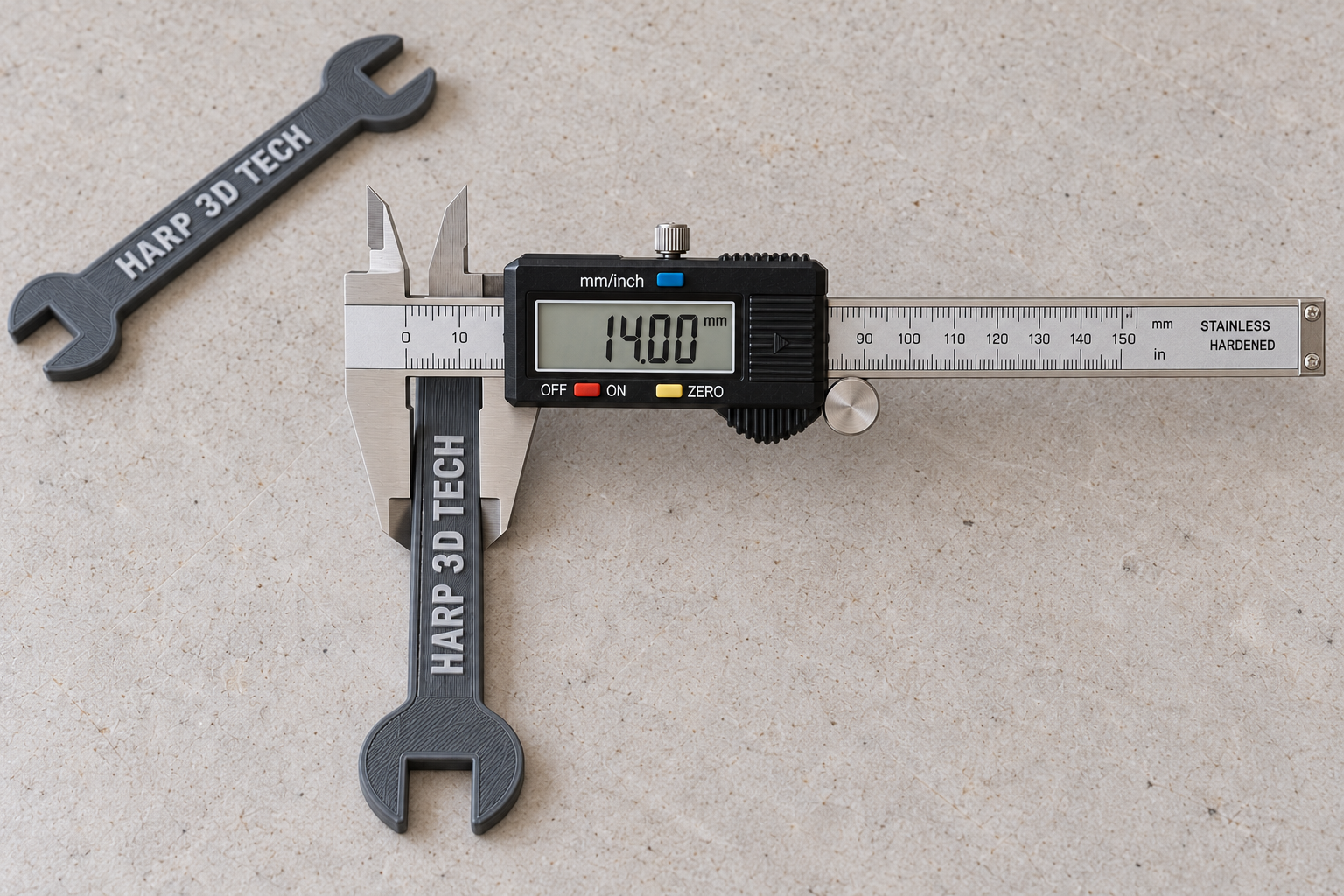Digital caliper showing 14.00 mm across a gray HARP printed wrench handle &mdash; illustrative composite